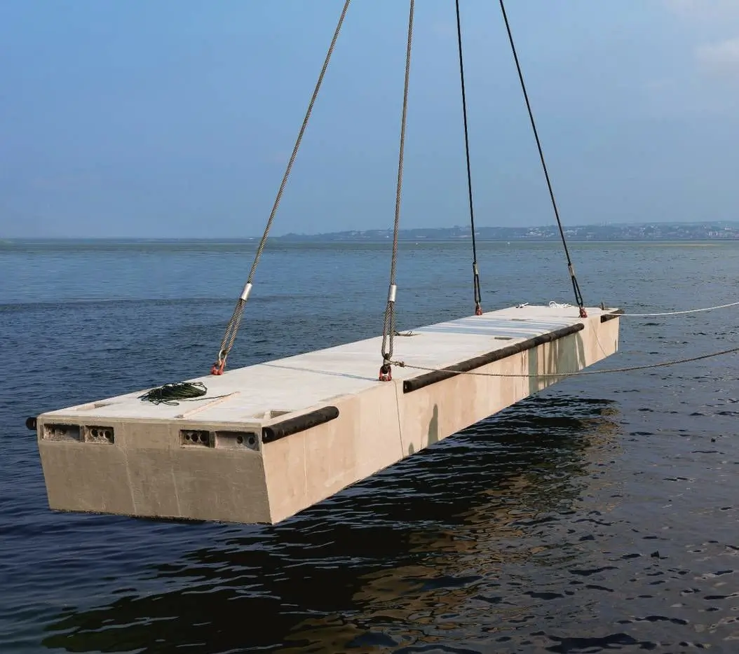 First concrete floating pontoon being lifted into place at Bali Benoa Marina